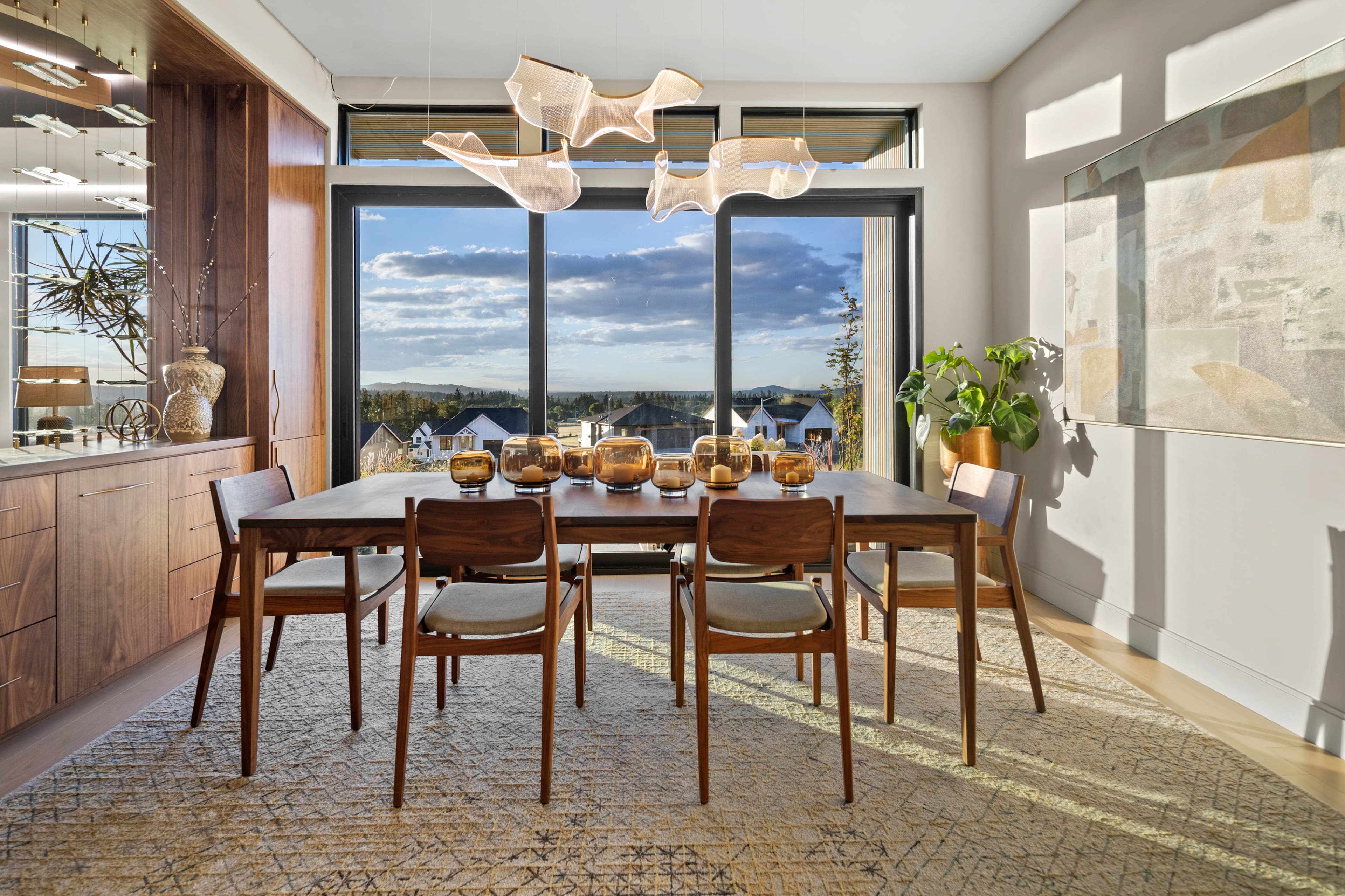 Dining room with walls of glass and wine-country views in the Creekside Homes Street of Dreams house