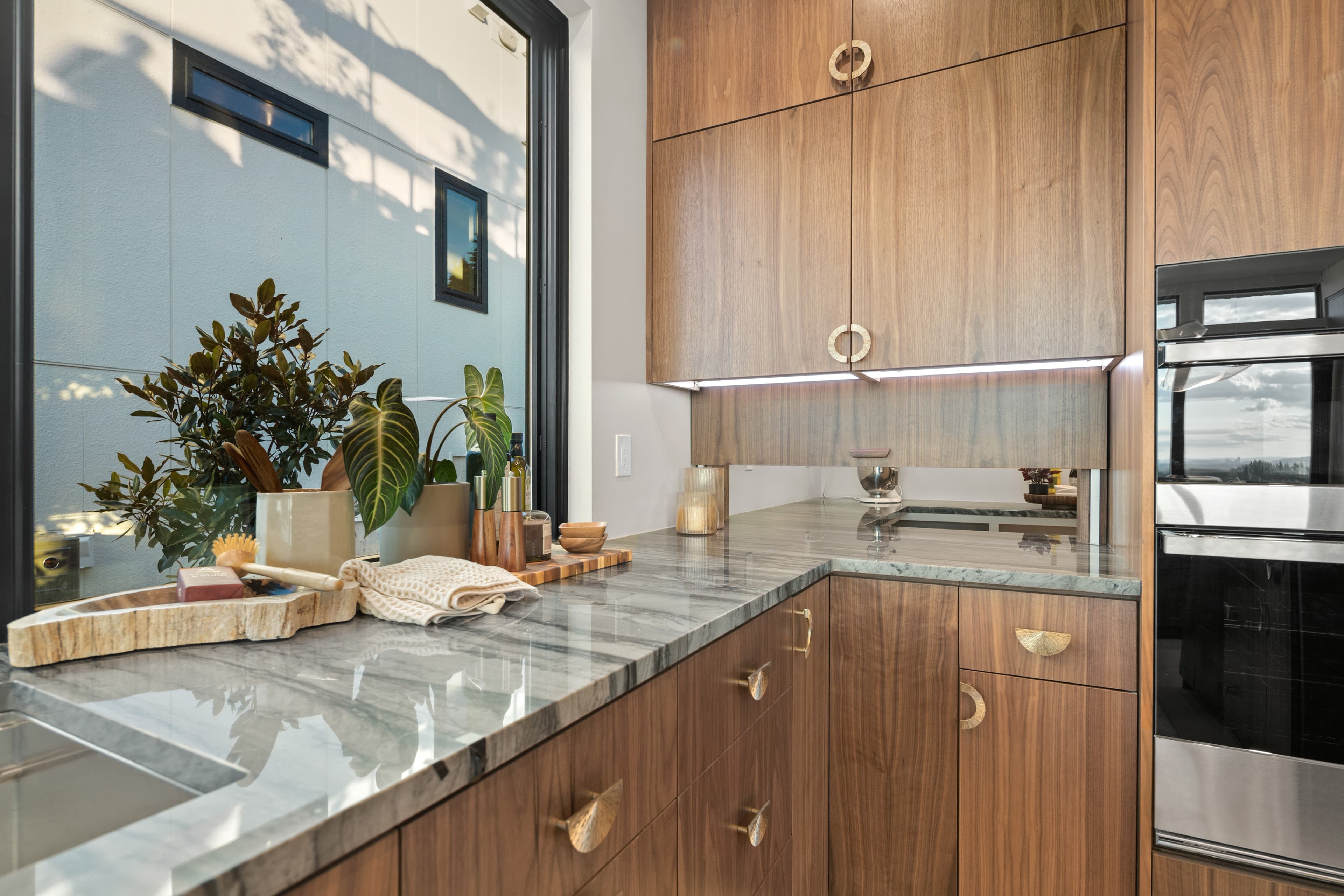 Walnut chef's kitchen with a sculptural island in the Creekside Homes Street of Dreams house